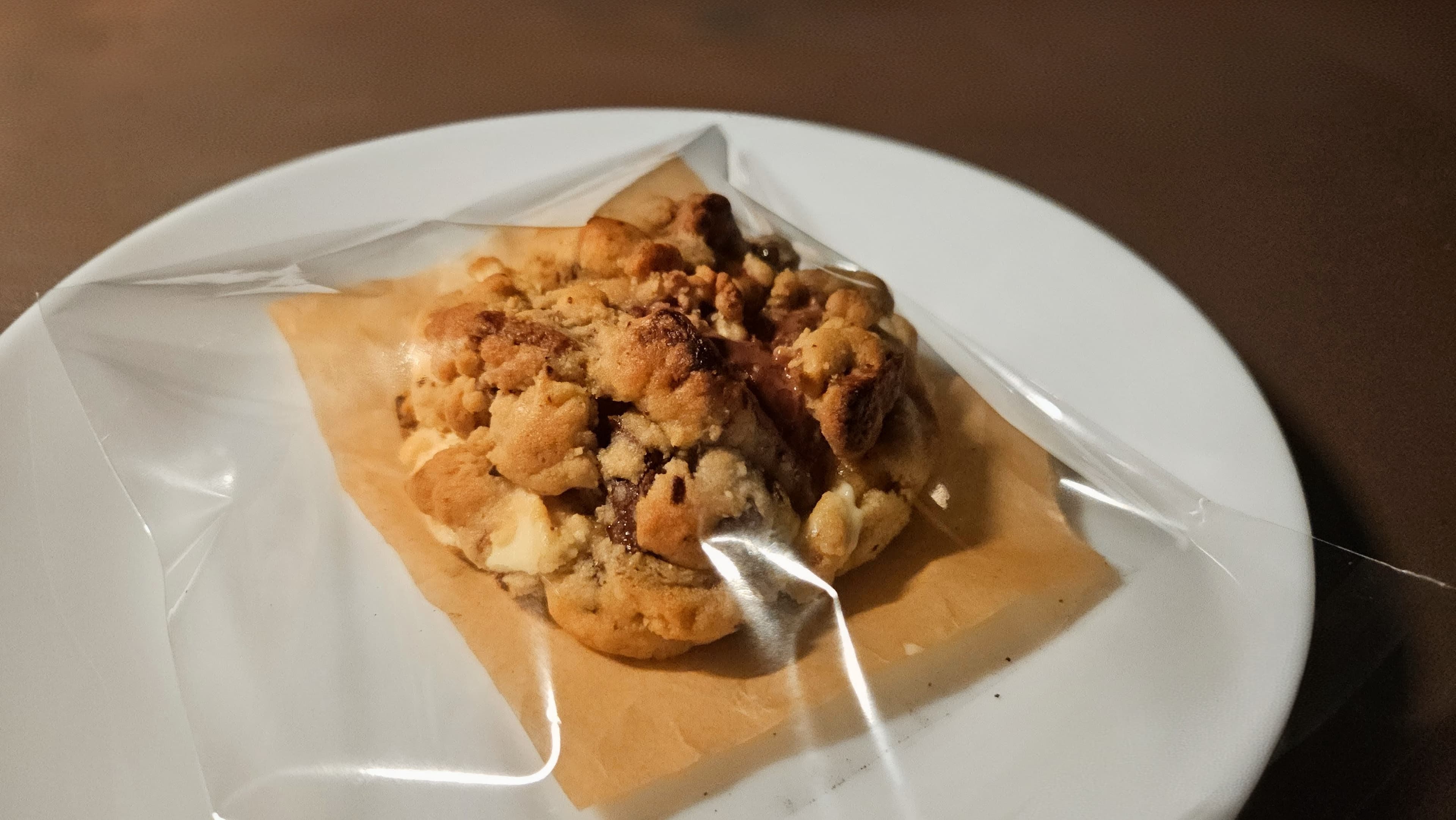 A single cookie plated late at night.