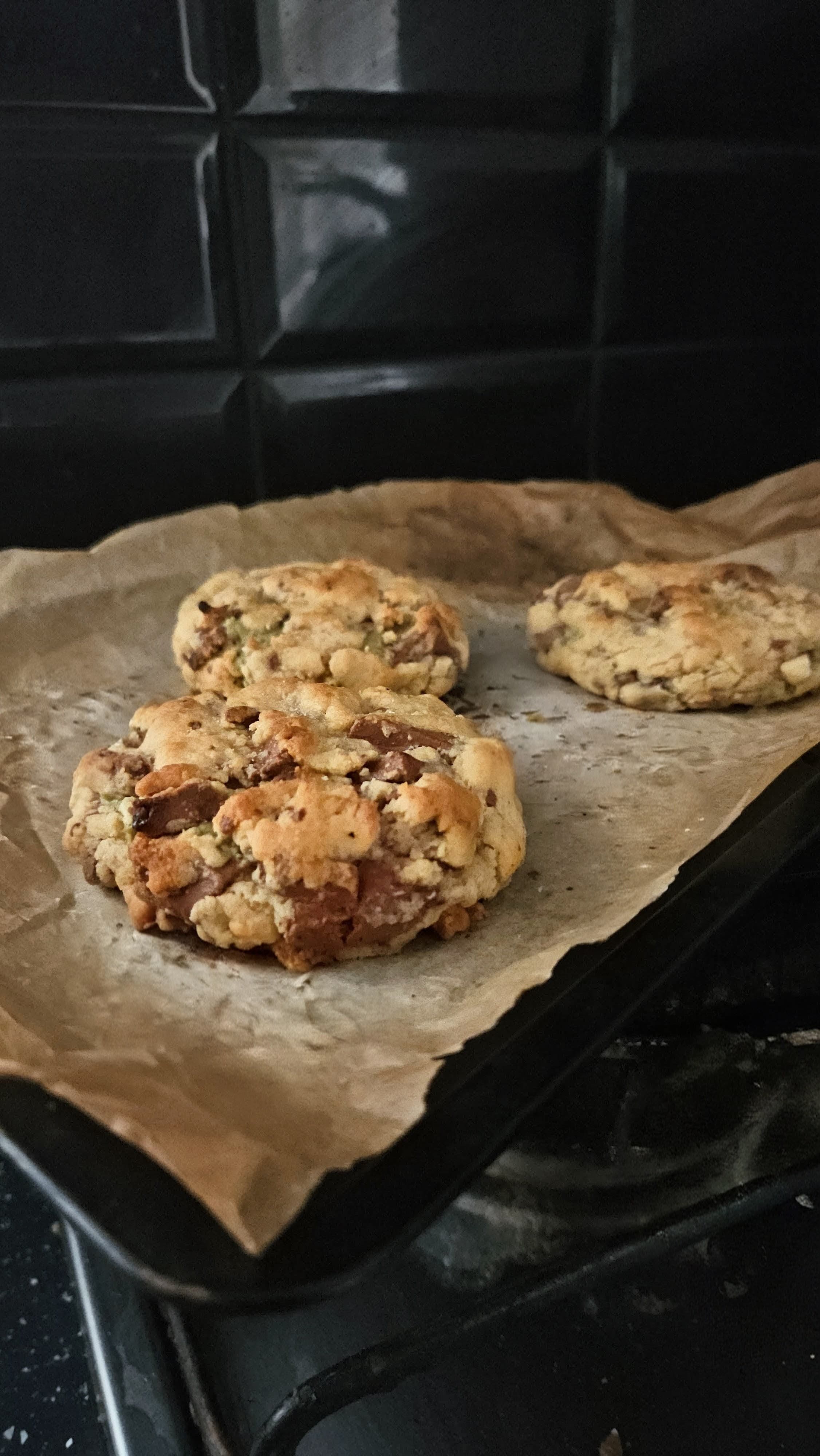 A tray of fresh-baked cookies resting on the hob.